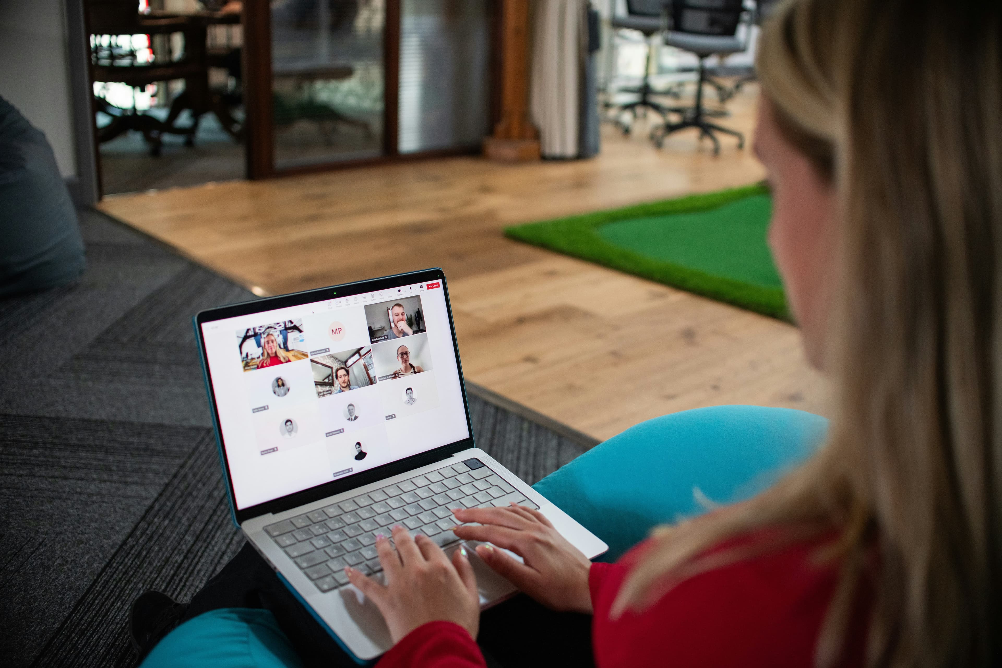 Interview and select your ideal candidate Person conducting an online video interview on a laptop while reviewing multiple candidates on screen